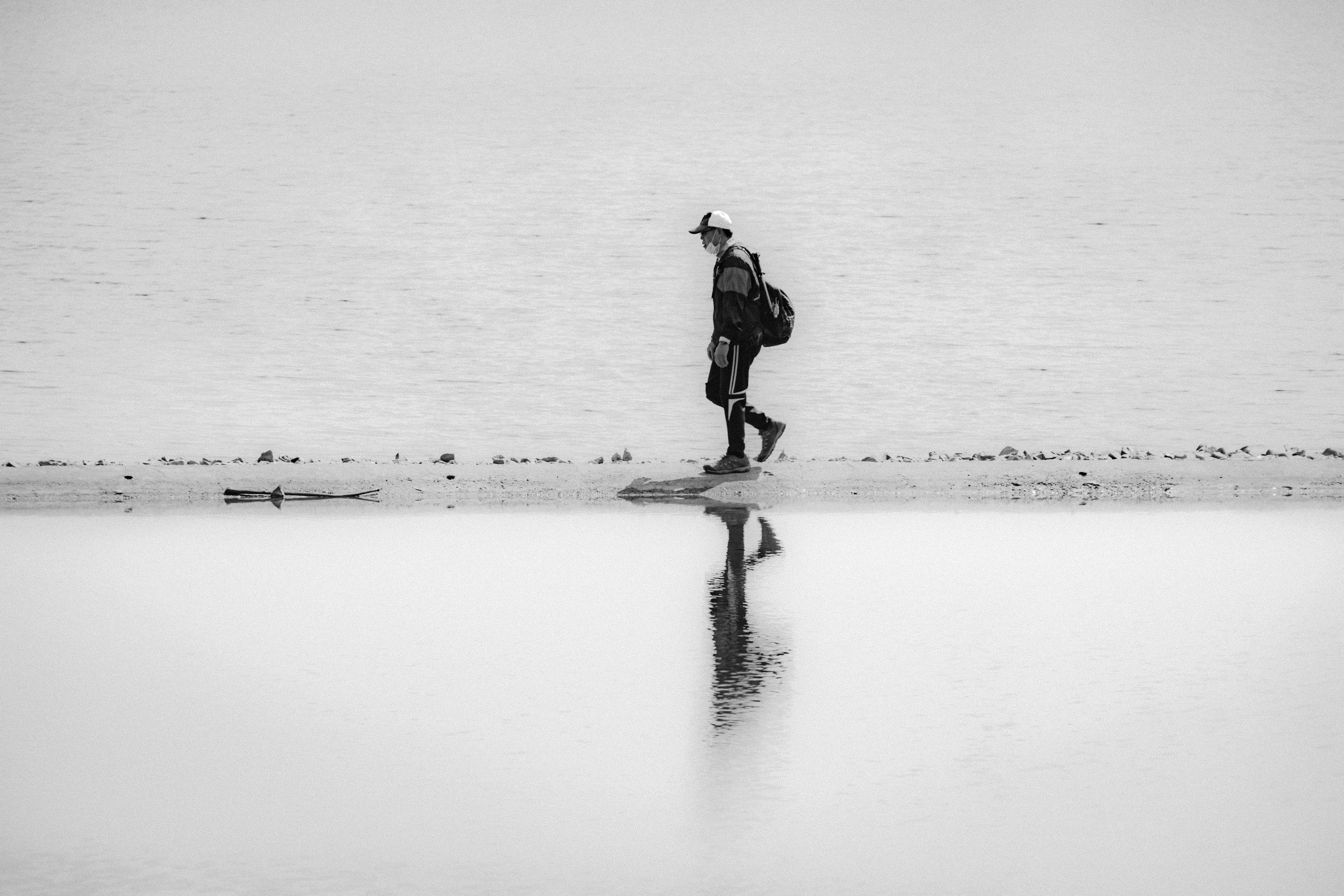 man in black jacket standing on snow covered ground during daytime